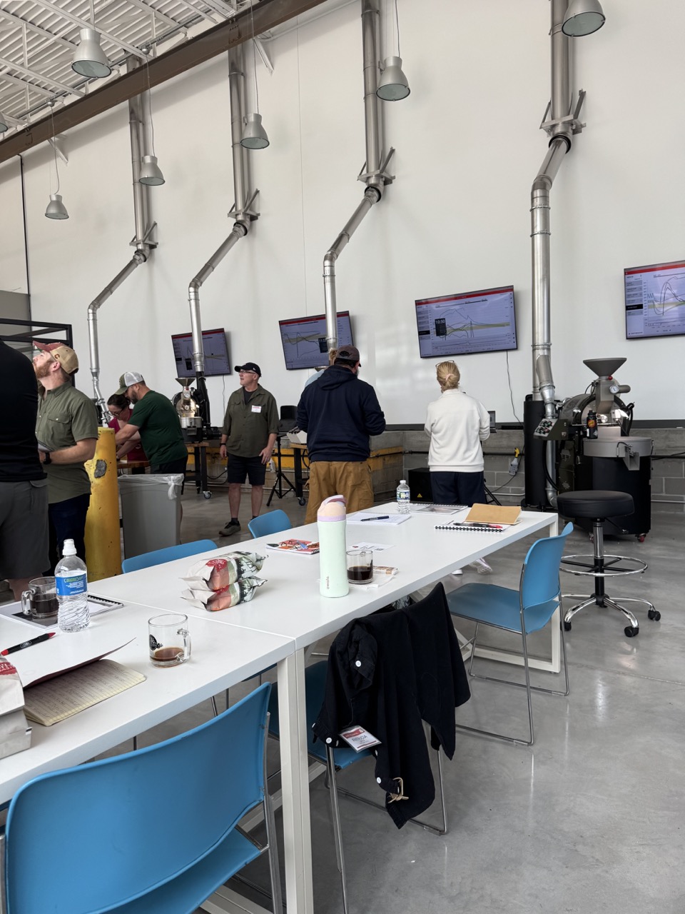 People looking at coffee roasting machines